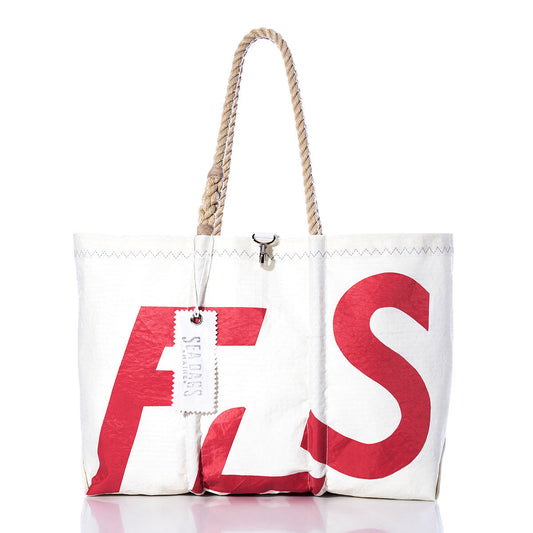 Vintage Flying Scot Large Tote by Sea Bags with bold red lettering, sturdy rope handles, and a white Sea Bags tag, displayed on a white background. This handcrafted Maine tote is the ideal sailboat bag for nautical enthusiasts. by Sea Bags