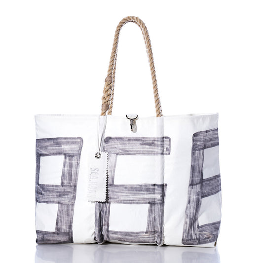 Sea Bags’ Vintage 868 Large Tote—crafted in Maine—features hand-spliced rope handles, bold gray block-style lettering, a small metal clasp, and a tag hanging from one handle for a classic vintage sail-inspired look. by Sea Bags