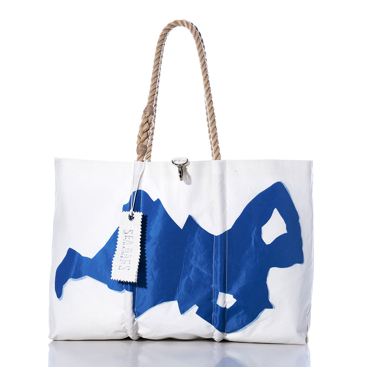 Sea Bags Vintage Highlander Large Tote: Handmade in Maine from white sailcloth, this spacious tote features sturdy rope handles, a striking blue abstract swimmer graphic, and a signature white tag on one handle—blending nautical style with enduring craftsmanship. by Sea Bags