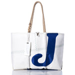 White sailcloth tote bag with rope handles, featuring a bold navy blue letter J on the front, visible stitching, and a white tag attached to one handle. The Sea Bags Vintage J70 Large Tote is part of our collection of handcrafted totes, offering both durability and timeless style. by Sea Bags