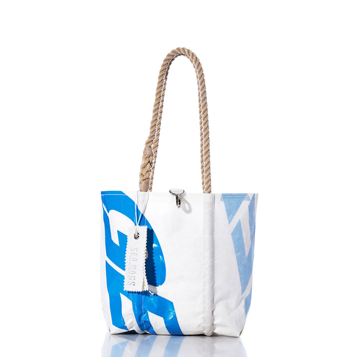 The Vintage GES24 Handbag by Sea Bags features a white and blue design with hemp rope handles, a metal clasp, and a tag bearing the Sea Bags brand. The bag stands upright against a white background, evoking classic vintage handbag style. by Sea Bags