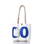 Sea Bags’ Vintage 0 Handbag features a plain white design accented with subtle sail insignias, blue lettering, and sturdy hemp rope handles. A tag is attached, and the nautical details lend timeless charm to this classic tote. by Sea Bags