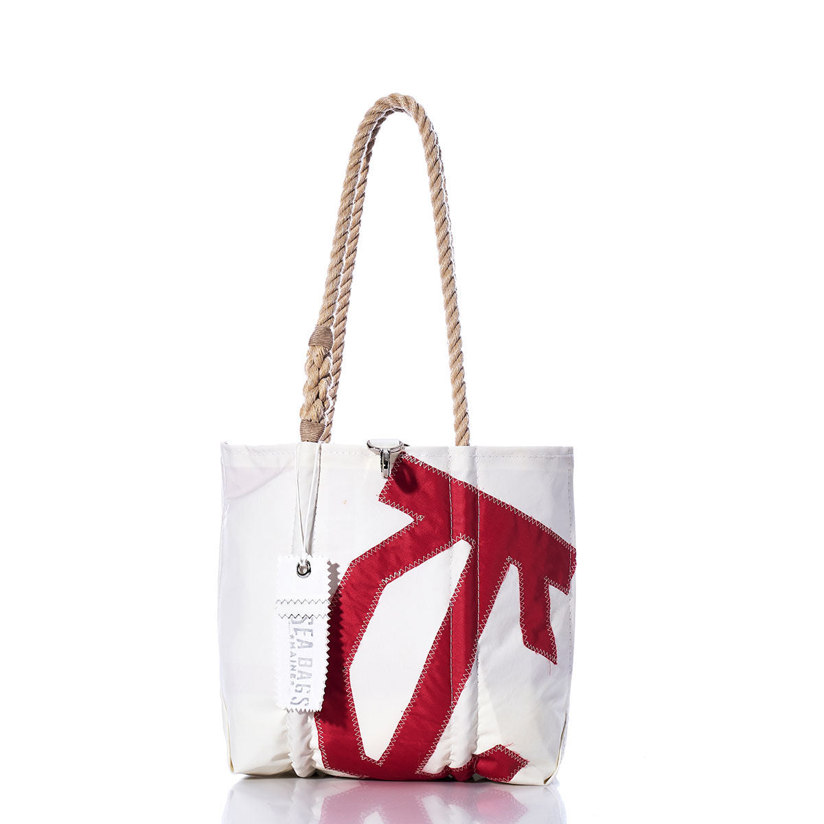 Sea Bags Vintage International One Design Handbag featuring a white exterior with a red stitched sail insignia design, sturdy hemp rope handles, and an exposed zipper. A Sea Bags tag is attached to the handle. The handbag is photographed against a white background, highlighting its nautical charm. by Sea Bags