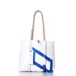 The Sea Bags Vintage 470 Handbag is a white tote featuring hemp rope handles and a blue geometric design inspired by vintage sail insignias, with a SEA BAGS tag, displayed against a white background. by Sea Bags