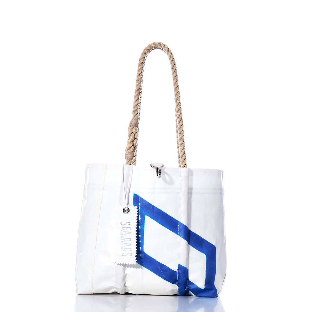 The Sea Bags Vintage 470 Handbag is a white tote featuring hemp rope handles and a blue geometric design inspired by vintage sail insignias, with a SEA BAGS tag, displayed against a white background. by Sea Bags