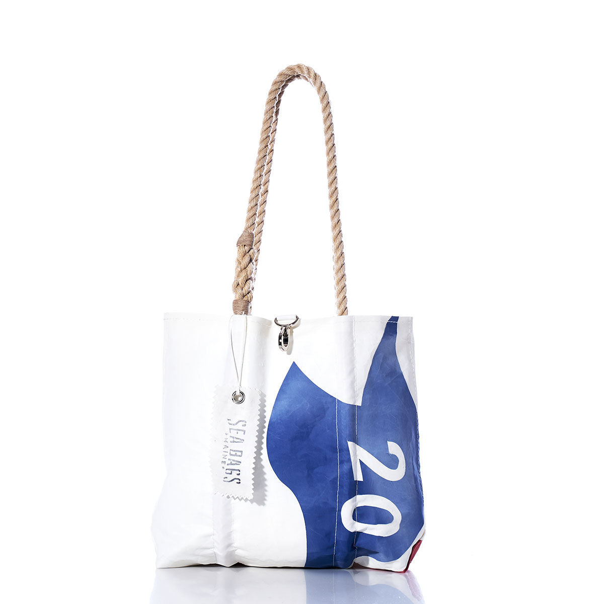 Sea Bags Vintage Harbor 20 Handbag—a white tote featuring a blue number 20 inspired by sail insignias, sturdy hemp rope handles, and a signature Sea Bags tag, photographed against a white background. by Sea Bags