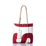Introducing the Vintage SA Handbag by Sea Bags—a tote featuring a striking red and white abstract design, durable hemp rope handles, and a SEABAGS tag attached to one handle. Inspired by vintage handbag styles, this bag subtly incorporates sail insignia elements for a unique maritime touch. by Sea Bags