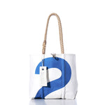 The Vintage Blue 2 Handbag by Sea Bags is a white tote adorned with a bold blue number 2, sturdy hemp rope handles, and finished with a branded Sea Bags tag and subtle sail insignias, photographed against a clean white background. by Sea Bags