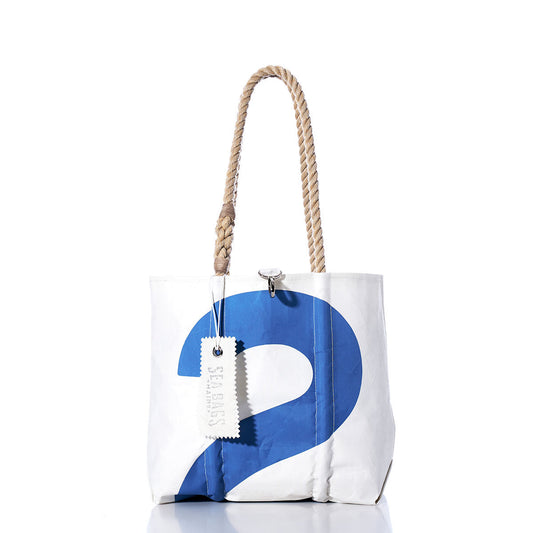 The Vintage Blue 2 Handbag by Sea Bags is a white tote adorned with a bold blue number 2, sturdy hemp rope handles, and finished with a branded Sea Bags tag and subtle sail insignias, photographed against a clean white background. by Sea Bags