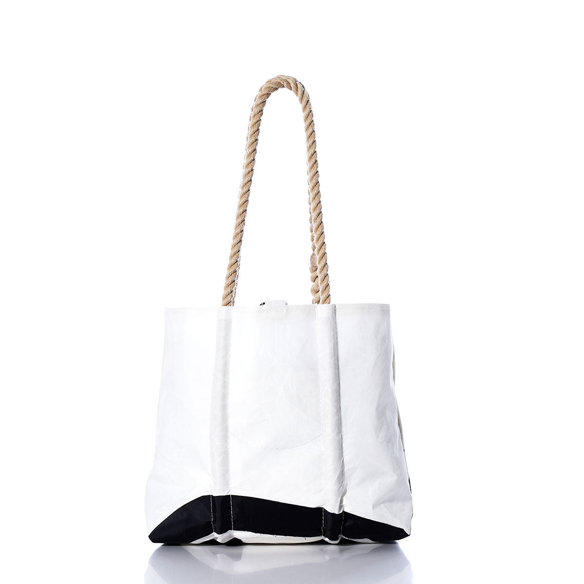 White tote bag with sturdy hemp rope handles and a black bottom, shown on a white background with a subtle reflection below. The Sea Bags Vintage CS21 Handbag showcases classic sail insignias, bringing a nautical flair to its timeless design. by Sea Bags