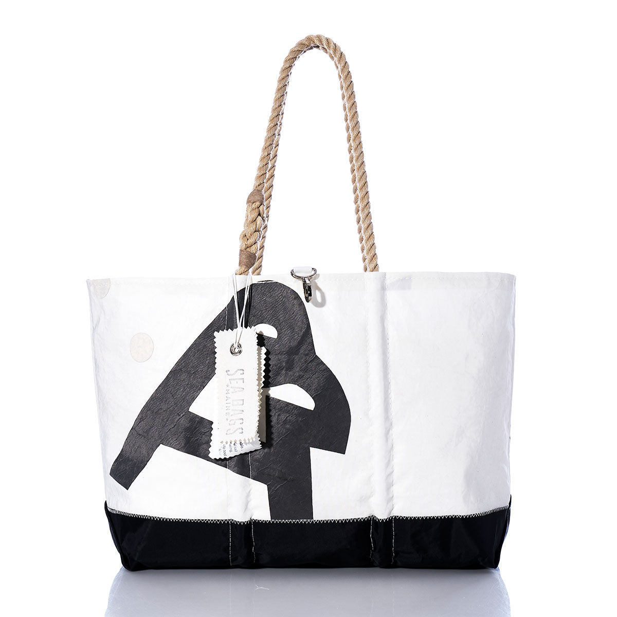 Vintage Allmand Ogunquit Beach Tote by Sea Bags in white and black, featuring a rope handle and a “Sea Bags” tag, made from recycled sail cloth and photographed against a white background. by Sea Bags