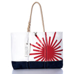 Introducing the Vintage Laser Ogunquit Beach Tote by Sea Bags—a spacious beach tote crafted from recycled sail cloth, featuring a striking red sunburst graphic on white with a navy blue bottom. Designed with sturdy rope handles and finished with a distinctive white “SEA BAGS” tag attached to the handle, this eco-friendly accessory brings effortless seaside style to your summer adventures. by Sea Bags