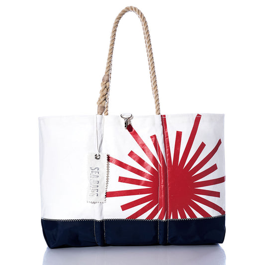 Introducing the Vintage Laser Ogunquit Beach Tote by Sea Bags—a spacious beach tote crafted from recycled sail cloth, featuring a striking red sunburst graphic on white with a navy blue bottom. Designed with sturdy rope handles and finished with a distinctive white “SEA BAGS” tag attached to the handle, this eco-friendly accessory brings effortless seaside style to your summer adventures. by Sea Bags
