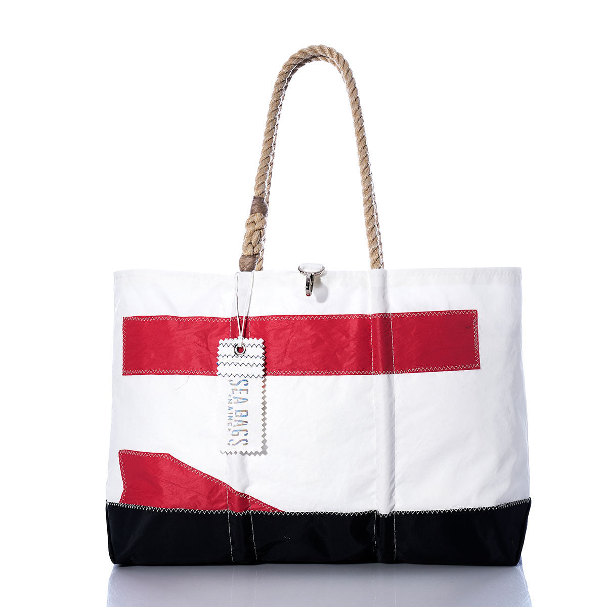 Introducing the Vintage Red 71 Ogunquit Beach Tote by Sea Bags—a spacious white tote bag made from recycled sail cloth, adorned with bold red and black rectangular accents. It features sturdy rope handles and a signature Sea Bags tag attached to one handle, seamlessly combining timeless style and eco-friendly craftsmanship inspired by classic sail designs. by Sea Bags