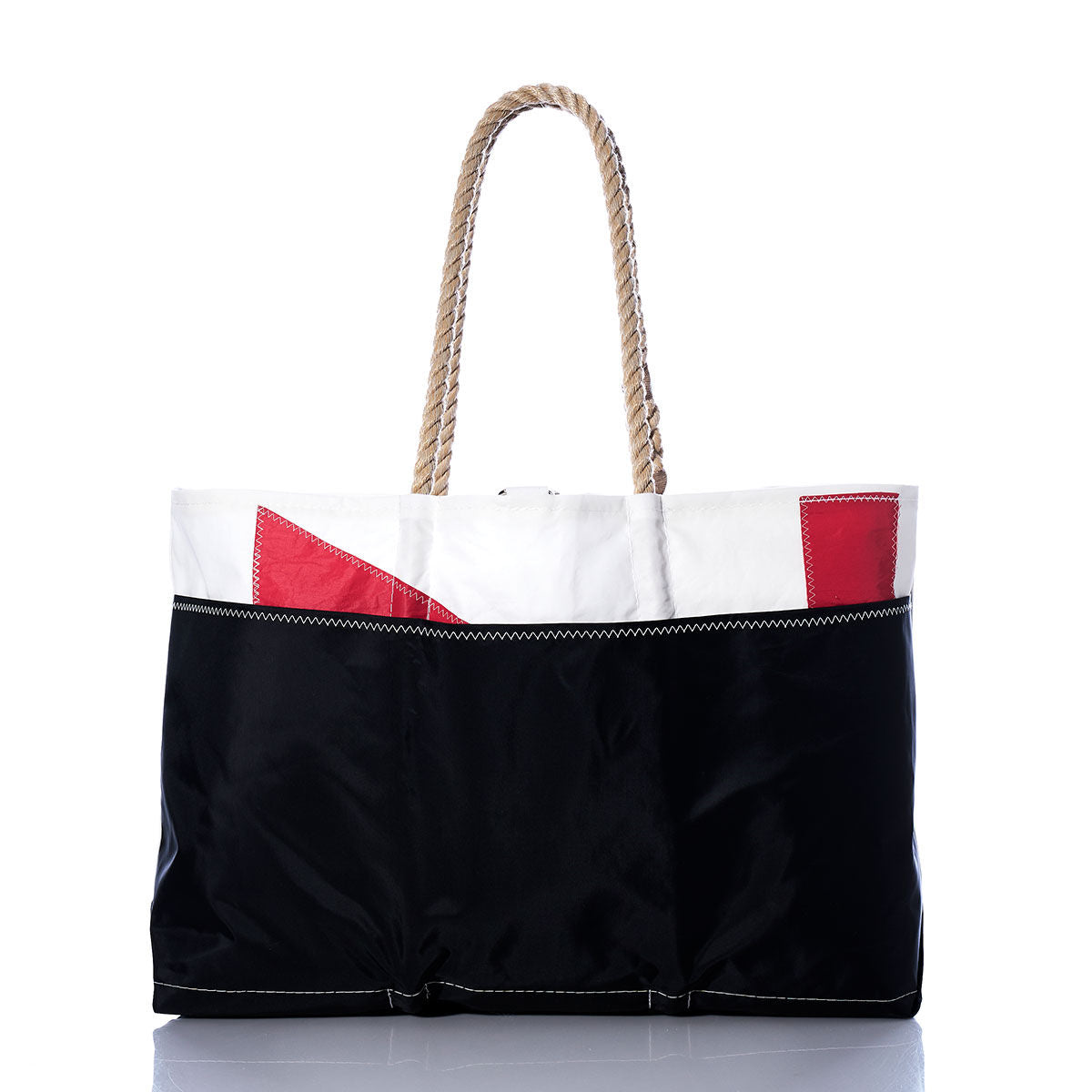 Introducing the Sea Bags Vintage Red 71 Ogunquit Beach Tote, a spacious and durable beach tote crafted from recycled sail cloth. Featuring a sturdy rope handle, this bag combines a classic black lower half with a crisp white upper section accented by bold red geometric details. Its timeless design captures the charm of a vintage sail while offering coastal style and sustainability, shown here displayed on a white background. by Sea Bags