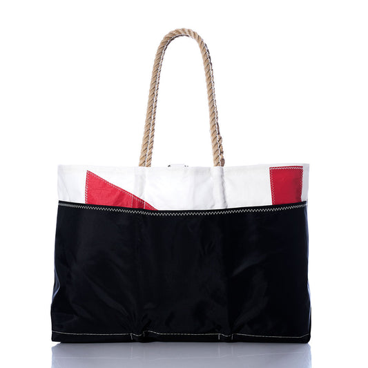 Introducing the Sea Bags Vintage Red 71 Ogunquit Beach Tote, a spacious and durable beach tote crafted from recycled sail cloth. Featuring a sturdy rope handle, this bag combines a classic black lower half with a crisp white upper section accented by bold red geometric details. Its timeless design captures the charm of a vintage sail while offering coastal style and sustainability, shown here displayed on a white background. by Sea Bags
