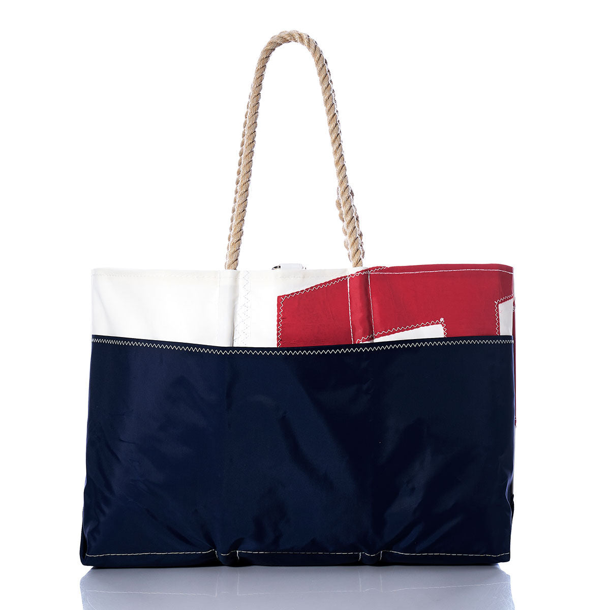 The Vintage USA Ogunquit Beach Tote by Sea Bags is a spacious tote bag made from recycled sail cloth, showcasing navy blue, white, and red color blocks. Designed with durable rope handles and distinctive white stitching, this stylish beach tote is attractively presented on a white background. by Sea Bags