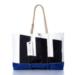 Introducing the Vintage Etchells Ogunquit Beach Tote by Sea Bags—a spacious beach tote crafted from recycled sail cloth, distinguished by its blue bottom, white upper section, bold black geometric shapes, sturdy rope handles, and signature SEA BAGS tag. This tote effortlessly blends vintage Etchells charm with modern coastal style. by Sea Bags
