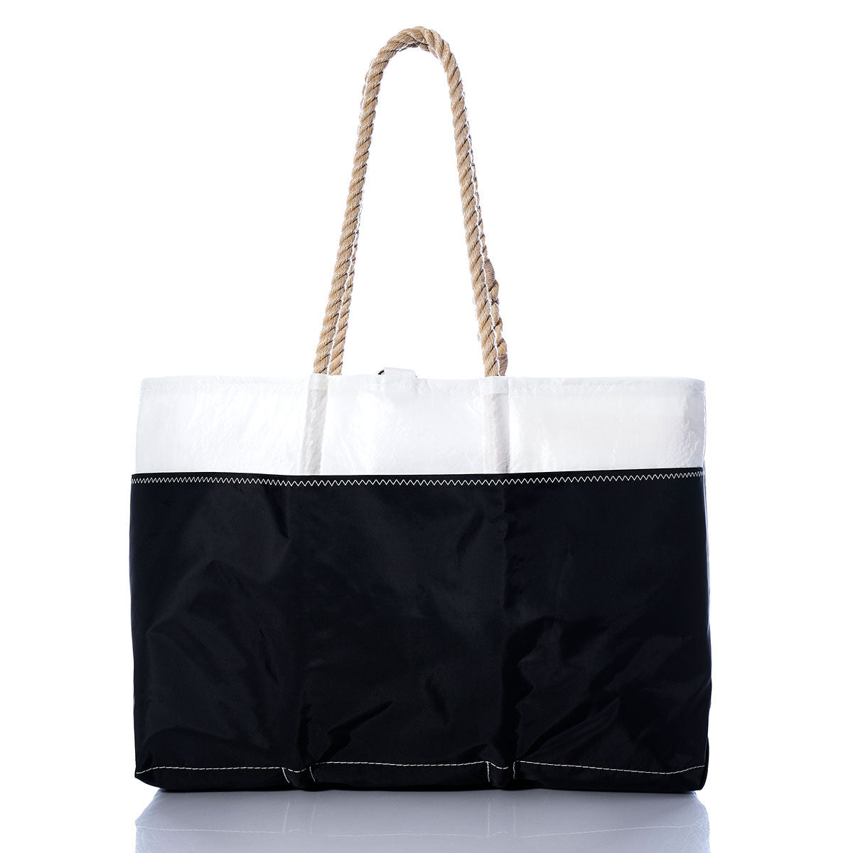 The Sea Bags Vintage Red C Ogunquit Beach Tote is a large beach tote bag made from recycled sail cloth, showcasing a white top, black bottom, and a sturdy twisted rope handle with vintage red stitching accents, displayed on a white background. by Sea Bags