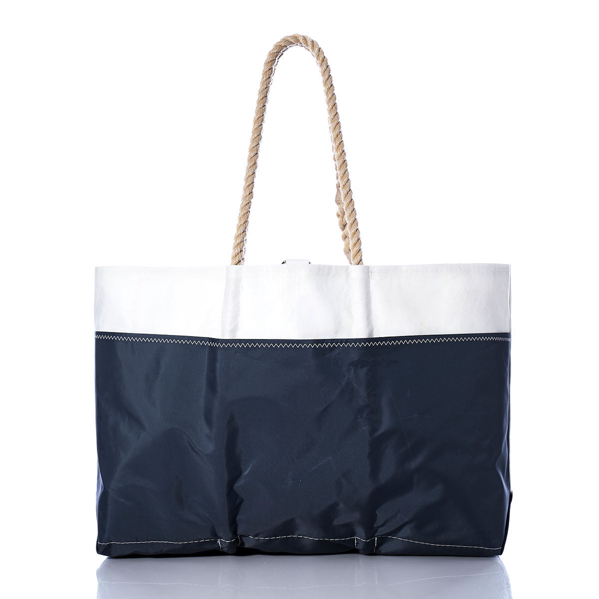The Sea Bags Vintage Colgate 26 Ogunquit Beach Tote is a rectangular beach tote bag crafted from recycled sail cloth, with a white top section, navy blue bottom section, and two sturdy rope handles—displayed on a white background as an homage to the classic style of Vintage Colgate 26 sails. by Sea Bags