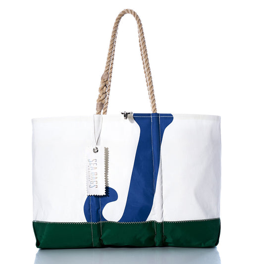 Vintage J24 Ogunquit Beach Tote by Sea Bags, crafted from recycled sail cloth in white and green with a bold blue letter J design, features sturdy rope handles and a signature Sea Bags tag on one handle. Photographed against a white background. by Sea Bags