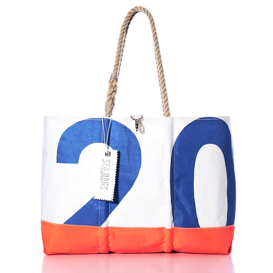 The Sea Bags Vintage Blue 20 Ogunquit Beach Tote features sturdy rope handles and is crafted from recycled sail cloth in white, blue, and orange. This spacious tote displays the number 20 and includes a signature Sea Bags tag. by Sea Bags