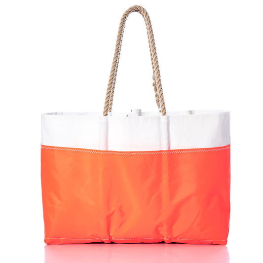 The Vintage Blue 20 Ogunquit Beach Tote by Sea Bags features a white upper paired with a vibrant blue lower section and is accented with thick rope handles, set against a white background. Crafted from recycled sail cloth, this beach tote blends durability with coastal style. by Sea Bags