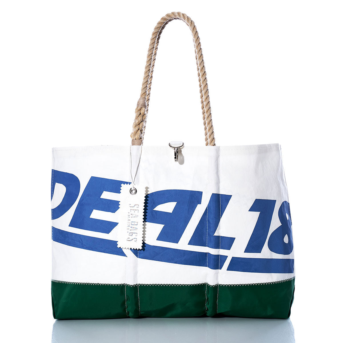 The Vintage Ideal 18 Ogunquit Beach Tote by Sea Bags features white and green recycled sail cloth panels, sturdy rope handles, bold blue and white graphic text, and a signature hanging SEA BAGS tag—offering the perfect blend of vintage beach bag style and coastal charm. by Sea Bags