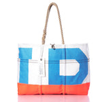 The Vintage Blue IP Ogunquit Beach Tote by Sea Bags features bold blue, white, and orange color blocks crafted from recycled sail cloth. With sturdy rope handles and a silver tag, this large beach tote beautifully blends style, sustainability, and seaside charm—shown perfectly against a white background. by Sea Bags