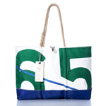 The Vintage Green 65 Ogunquit Beach Tote by Sea Bags is expertly crafted from recycled sail cloth and features a bold green and white number 65 design, a blue base, sturdy rope handles, and a signature white “SEABAGS” tag—making it both stylish and eco-friendly. by Sea Bags