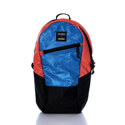 The Sea Bags Vintage Orange and Blue Crew Backpack is a sustainable, multicolored bag crafted from recycled sail cloth, showcasing a blue front, orange accents, black bottom, and a front zipper pocket—all displayed on a white background. by Sea Bags