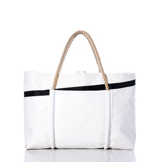 Handcrafted from recycled sail cloth, the Sea Bags Vintage Quantum Wharf Tote is a large white canvas tote bag featuring two tan rope handles and black accent stripes. Inspired by Portland, Maine, this sustainable tote is presented against a plain white background. by Sea Bags