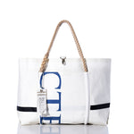 The Sea Bags Vintage CTED Wharf Tote, handcrafted in Portland, Maine from recycled sailcloth, features blue lettering on white fabric, sturdy rope handles, an exterior pocket, and a hanging tag. The tote is shown upright against a white background. by Sea Bags