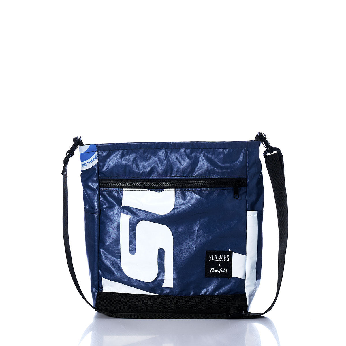 The Sea Bags Vintage White S Medium Voyager Crew Crossbody is a sustainable blue and white bag featuring a black adjustable strap, a front zipper pocket, and two logo patches near the bottom. Made from recycled polyester, it is displayed on a white background. by Sea Bags