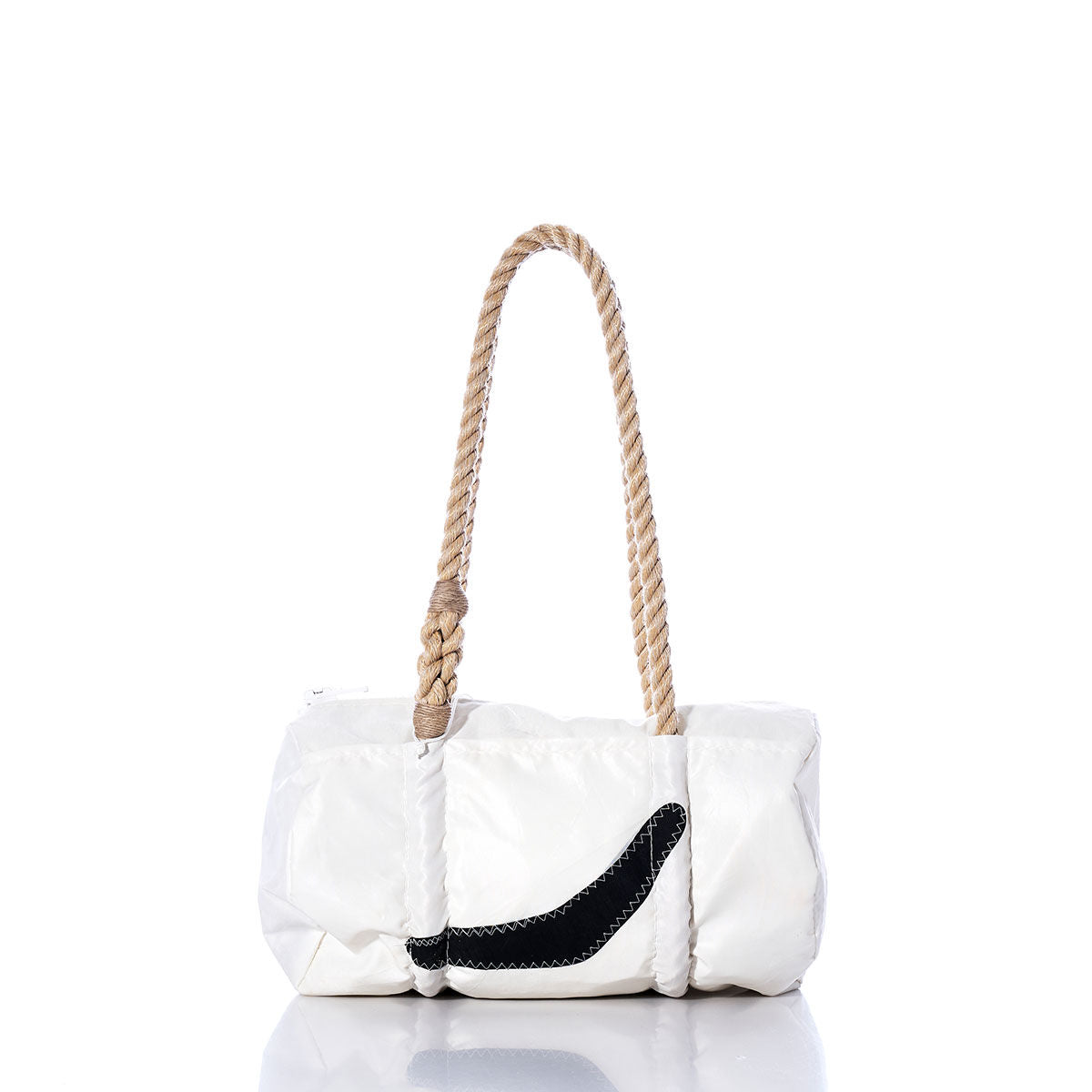 The Sea Bags Vintage Black Swoosh Baguette Bag features a white rectangular sail cloth body, accented with a bold black curved detail on the front and finished with a thick, hand-spliced rope handle. It is displayed on a reflective surface against a white background. by Sea Bags