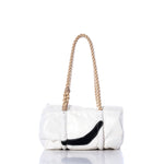 The Sea Bags Vintage Black Swoosh Baguette Bag features a white rectangular sail cloth body, accented with a bold black curved detail on the front and finished with a thick, hand-spliced rope handle. It is displayed on a reflective surface against a white background. by Sea Bags