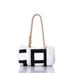 The Vintage SA Baguette Bag by Sea Bags is a white cylindrical bag with black geometric accents, featuring hand-spliced rope handles and shown against a plain white background. by Sea Bags