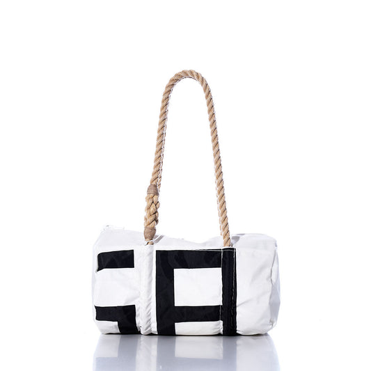 The Vintage SA Baguette Bag by Sea Bags is a white cylindrical bag with black geometric accents, featuring hand-spliced rope handles and shown against a plain white background. by Sea Bags