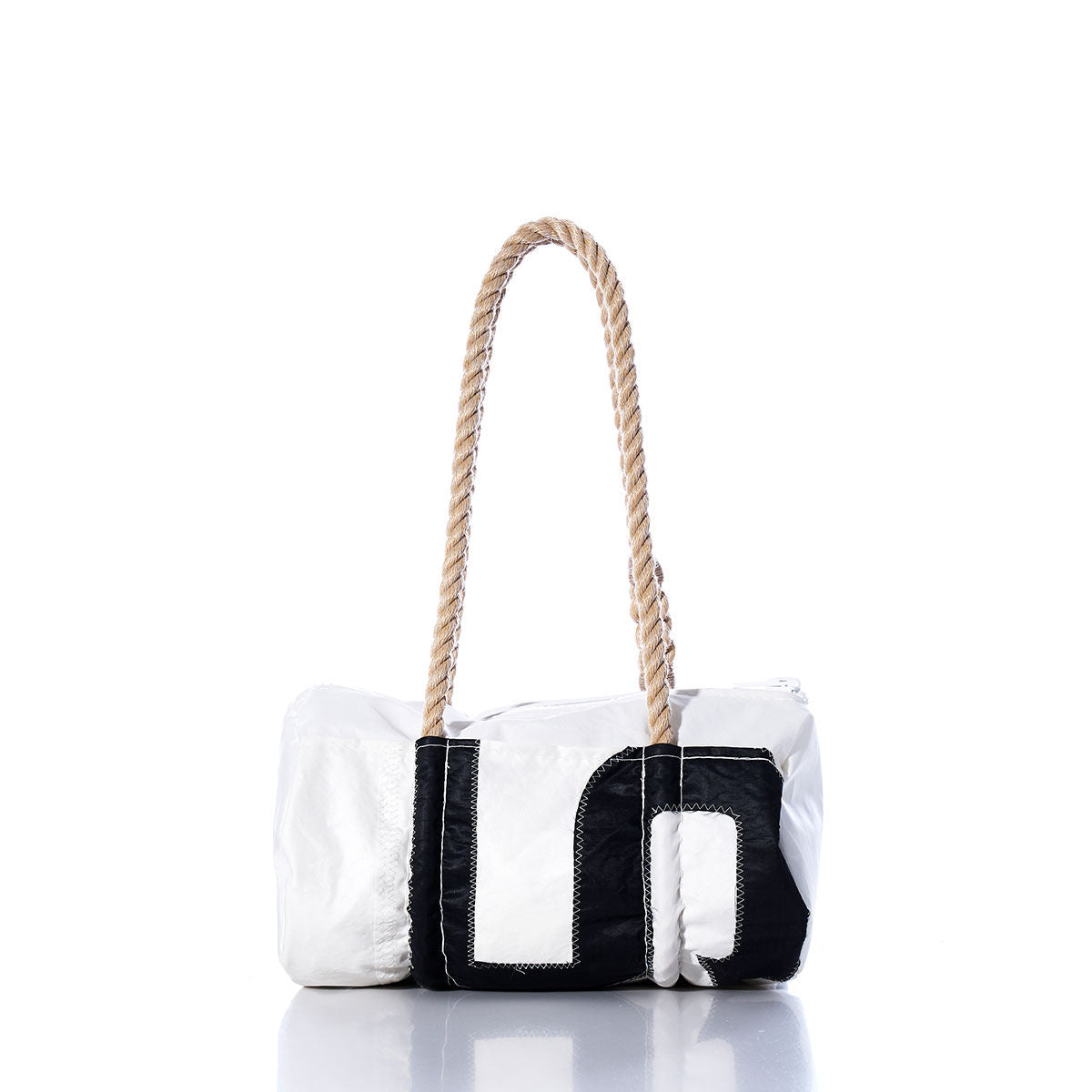 The Vintage 45 Baguette Bag by Sea Bags features a white and black rectangular design crafted from authentic sailcloth, with visible stitching and a thick, hand-spliced rope handle, displayed against a plain white background. by Sea Bags