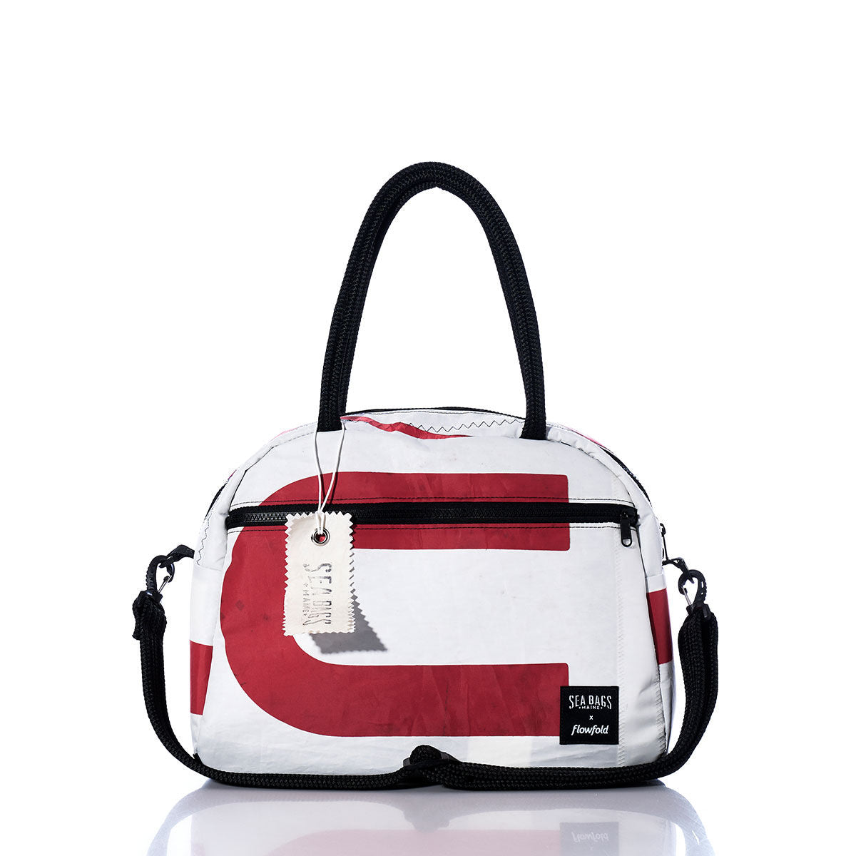 Introducing the Sea Bags Vintage US Essential Weekender Travel Bag—a small white and red duffel bag featuring black handles, a detachable strap, and a front zipper pocket. The signature Sea Bags label is attached near the bottom right corner. Stylish and compact, this travel bag makes an ideal carry-on for your next getaway. by Sea Bags