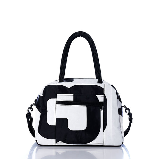 Sea Bags Vintage Black and White Essential Weekender Travel Bag features a striking geometric pattern in classic black and white, dual handles, a front zip pocket, and a detachable shoulder strap—making it the perfect carryon for your next getaway. A convenient trolley sleeve ensures easy transport. The bag is displayed against a white background. by Sea Bags