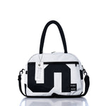 The Sea Bags Vintage Black 5 Essential Weekender Travel Bag features a striking black and white geometric pattern, sturdy black handles, a convenient front zipper pocket, and a distinctive white SEA BAGS tag attached to the handle—making it an ideal stylish option for your next adventure, whether as a compact carryon or weekender travel bag. by Sea Bags