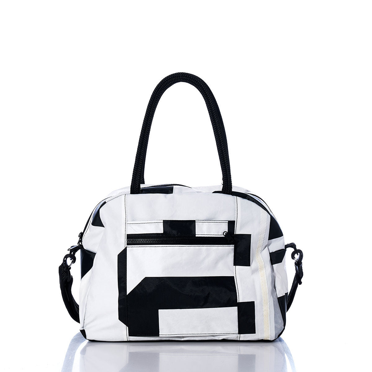 Sea Bags Vintage Black 5 Essential Weekender Travel Bag, featuring black geometric patterns, black handles, and a front zip pocket, is displayed on a white reflective surface—a stylish travel companion perfect for your next getaway. by Sea Bags