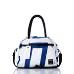 The Vintage Blue and White Essential Weekender Travel Bag by Sea Bags features a striking blue and white design with black handles and a shoulder strap, plus a front zipper pocket, tag, and the “Sea Bags” label—all set against a white background. Perfect as an overnight or carry-on bag for your next adventure. by Sea Bags