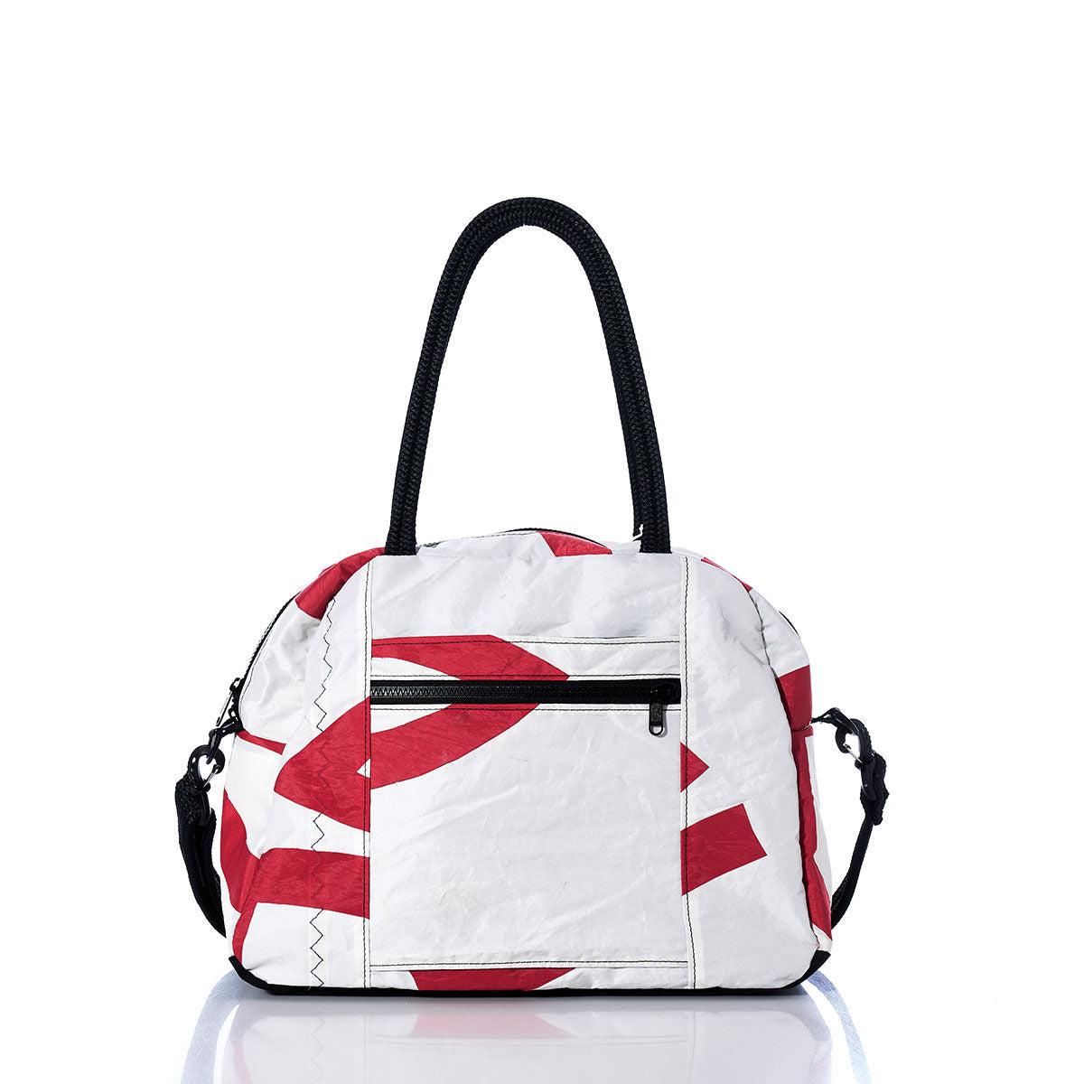 The Sea Bags Vintage Red and White Essential Weekender Travel Bag features red abstract patterns on a white background, black handles, a front zipper pocket, an adjustable shoulder strap, and a convenient trolley sleeve for easy travel. Designed as a compact carryon, the bag is displayed on a white reflective surface. by Sea Bags
