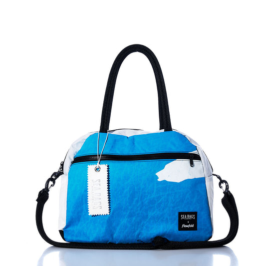 Elevate your travels with the Vintage Blue and White Essential Weekender Travel Bag from Sea Bags, featuring sturdy black handles, a detachable shoulder strap, a spacious front zipper pocket, and an authentic white Sea Bags tag—perfect as an overnight bag or your reliable go-to weekender travel companion. by Sea Bags