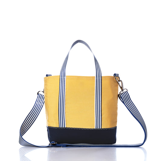 The Sea Bags Vintage Yellow Canvas Crossbody Tote, a limited edition bag in butter yellow canvas with navy blue accents, features white and blue striped handles and an adjustable shoulder strap, shown against a white background. by Sea Bags