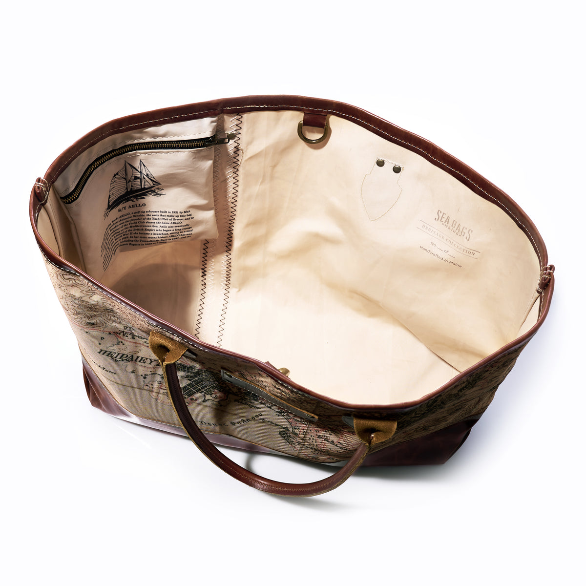 Sea Bags Heritage Aello Large Tote, featuring a vintage map design inspired by the classic yacht restoration of S/Y AELLO on the exterior, with printed text and graphics on the inner lining—shown from above against a white background.