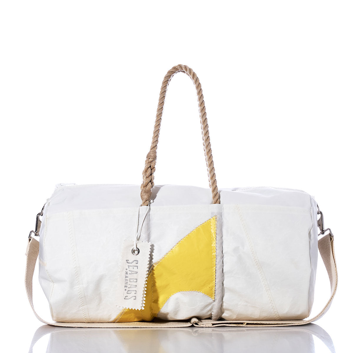 Sea Bags Vintage C Scow Duffel—a white duffel bag made from recycled sail cloth, featuring a yellow geometric design, rope handles, authentic sail insignias, and a signature Sea Bags tag—displayed against a white background. by Sea Bags