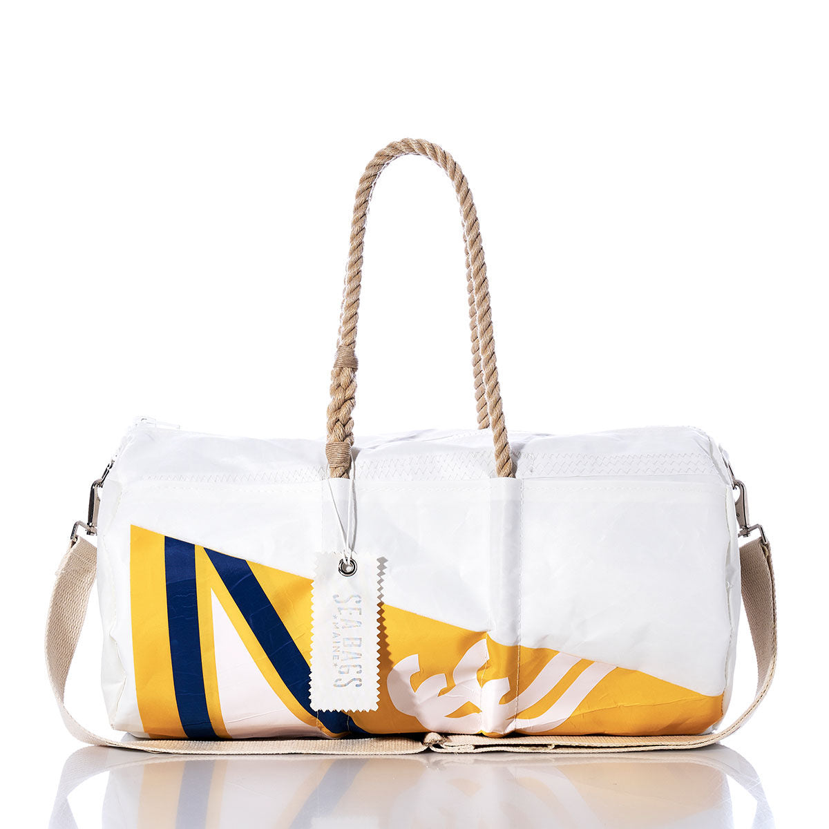 The Sea Bags Vintage Yellow Burgee Duffel is a white and yellow bag with blue diagonal stripes, crafted from recycled sail cloth. It features sturdy hemp rope handles, a beige shoulder strap, and comes with a white tag attached to one handle. by Sea Bags